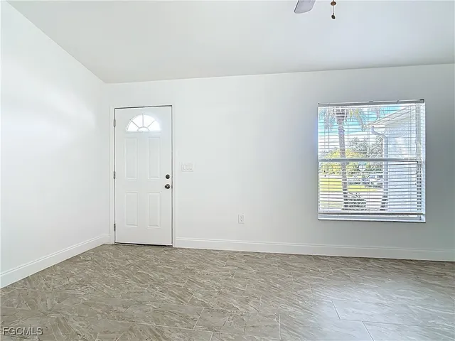 a view of an empty room with a window