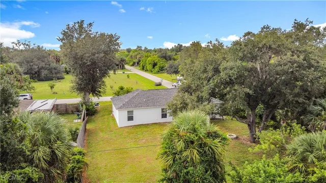 an aerial view of a house with swimming pool and garden