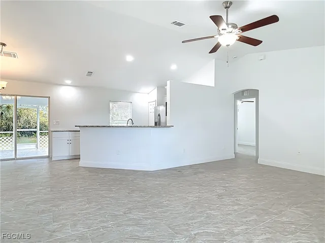 a view of a kitchen with a stove and a ceiling fan