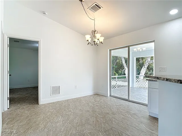 en empty room with windows and outdoor view