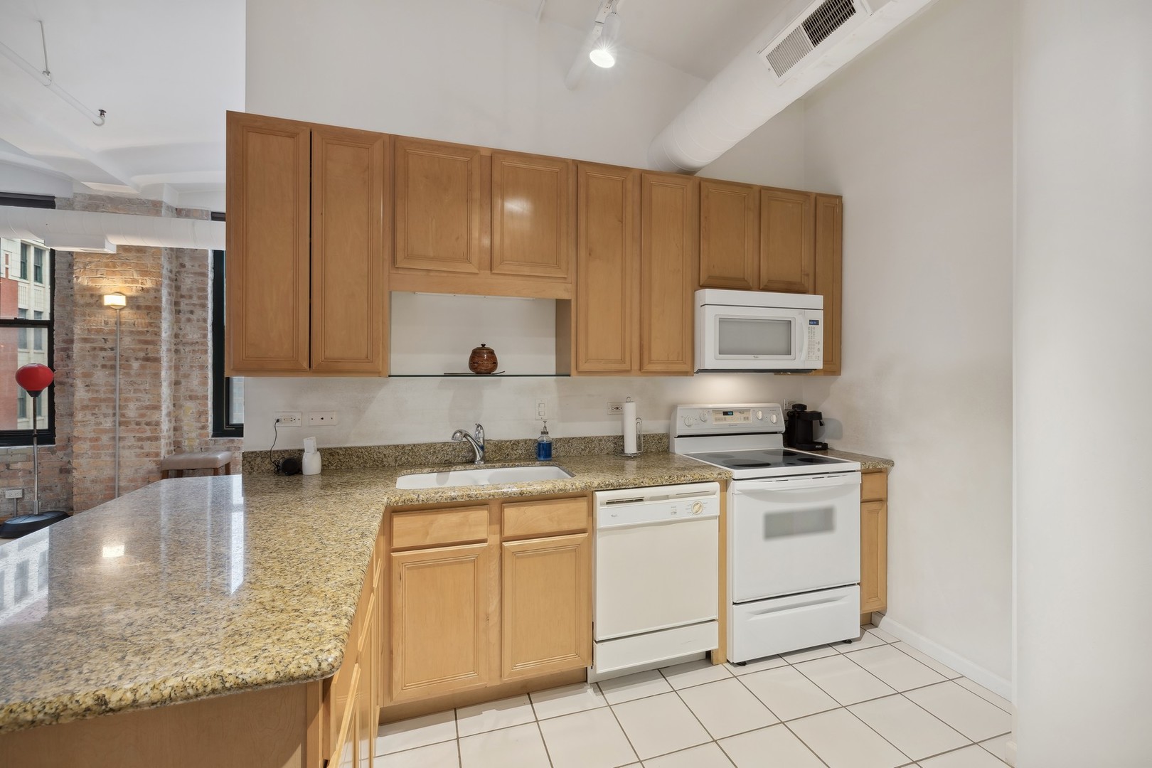 801 South Wells Street, Unit 510 Chicago, IL 60607 - Photo 6 of 11 a kitchen with stainless steel appliances granite countertop a sink stove and cabinets