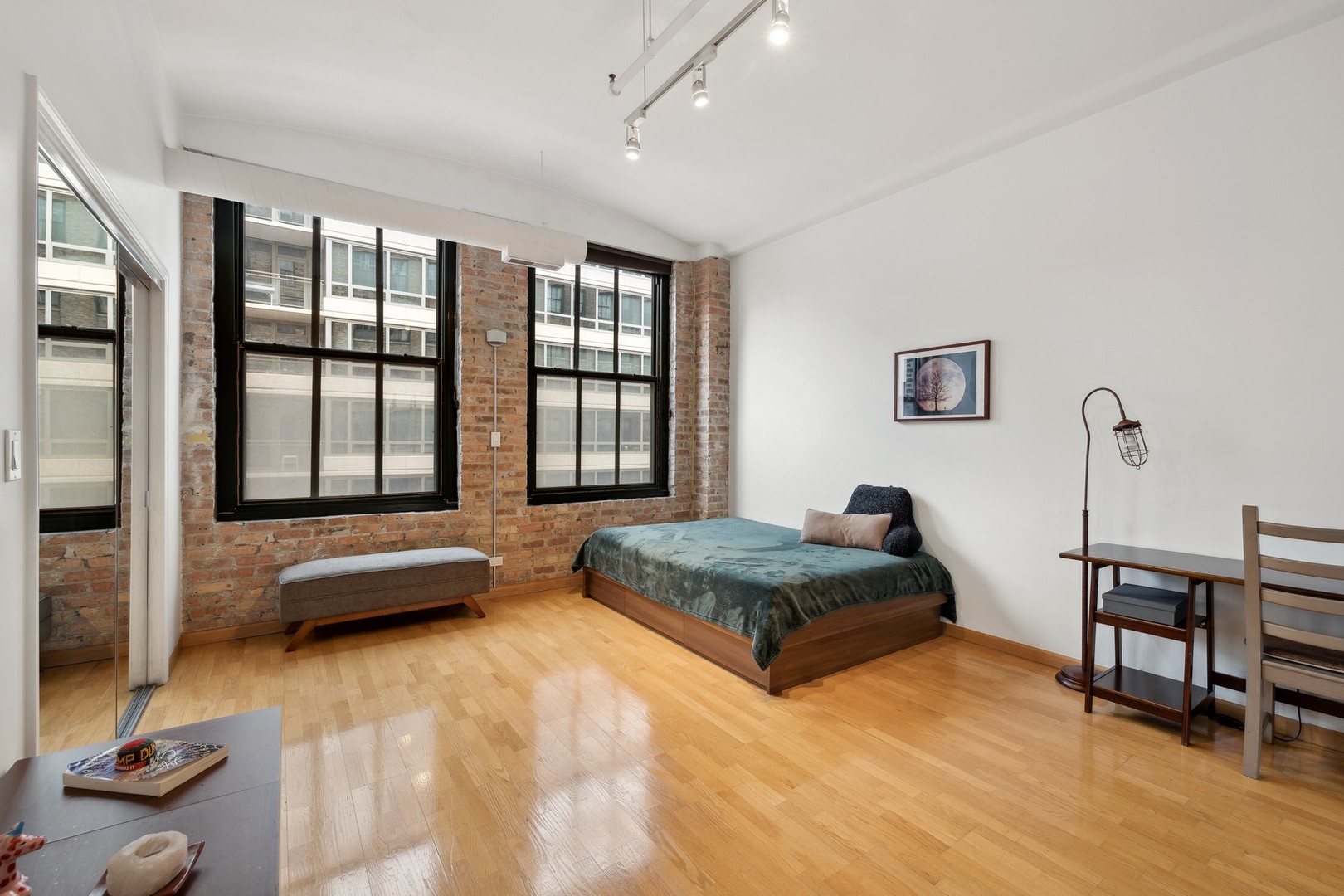 801 South Wells Street, Unit 510 Chicago, IL 60607 - Photo 7 of 11 a bedroom with furniture and a large window