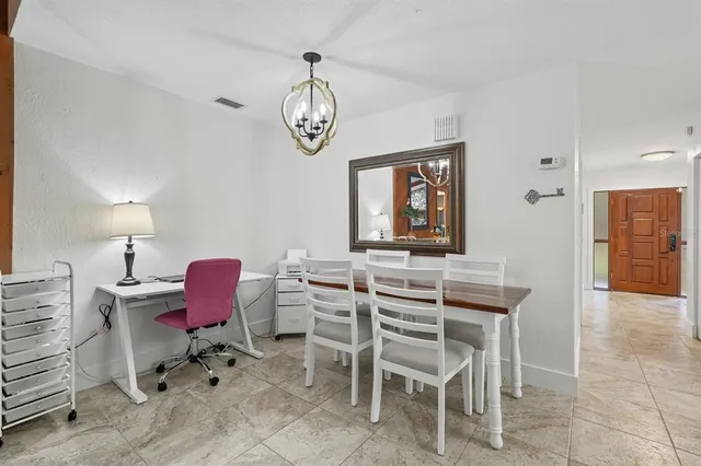 a work room with furniture and a potted plant