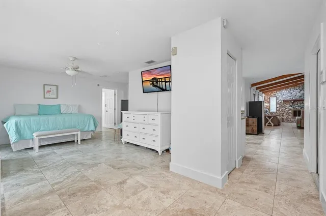 a spacious bedroom with a bed and a window