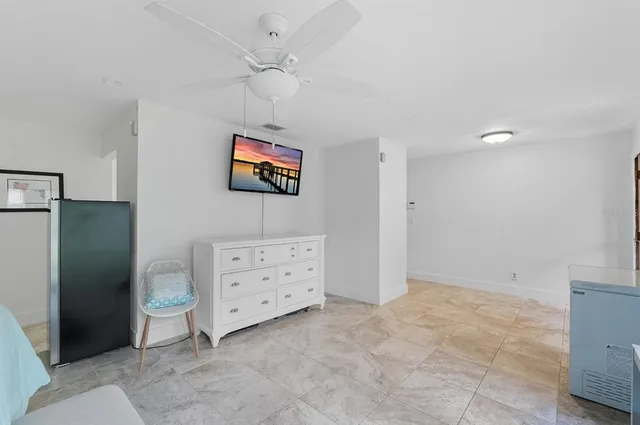 a bedroom with a bed dresser and a window