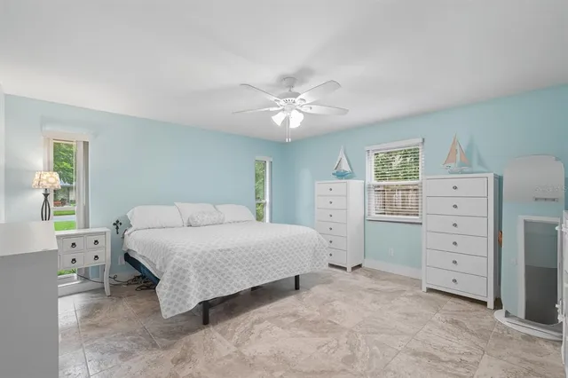 a bathroom with a granite countertop toilet sink and mirror