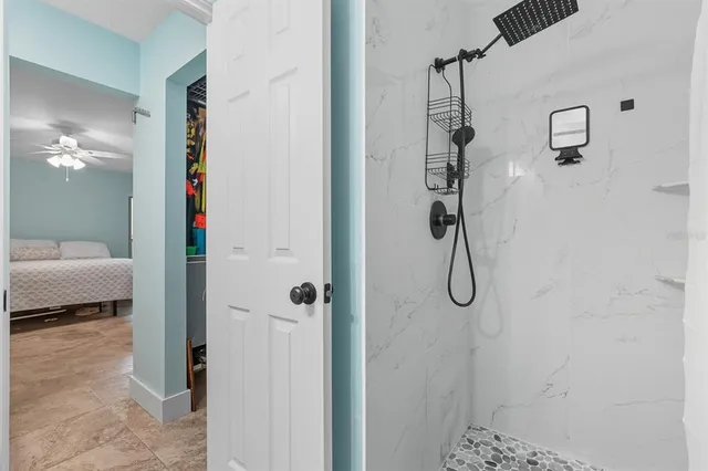 a bedroom with furniture and a large window