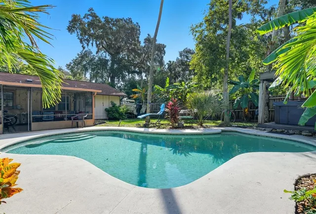 a view of a house with swimming pool and sitting area