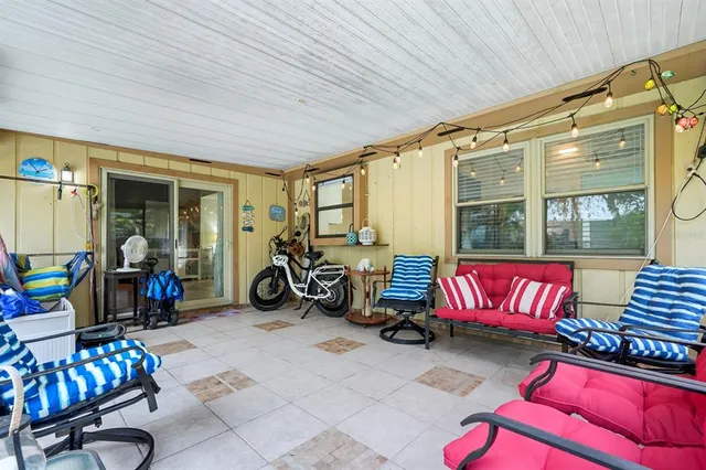 an aerial view of residential house with outdoor space and trees all around