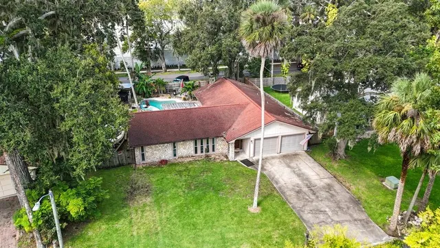 an aerial view of a house with a yard