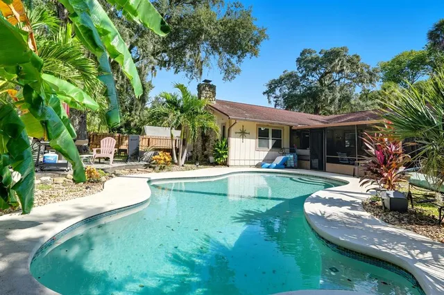 a living room with furniture a fireplace and a floor to ceiling window