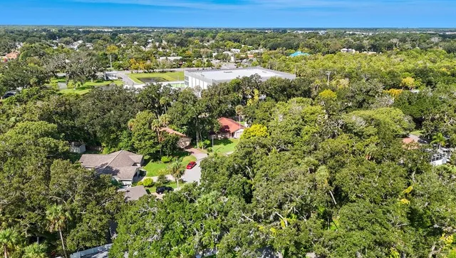 a living room with patio furniture and a floor to ceiling window