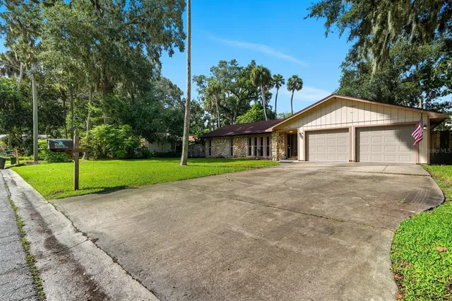 a view of backyard with swimming pool and sitting area