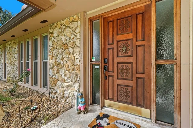 a view of a backyard with table and chairs and potted plants