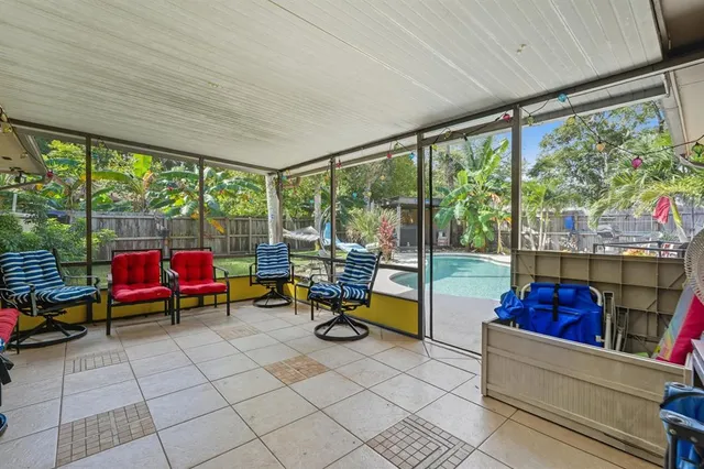 a view of a house with backyard and sitting area