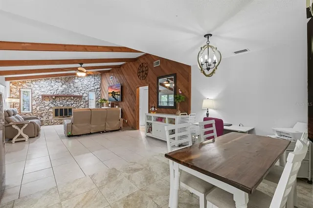 a kitchen with granite countertop a refrigerator stove and microwave