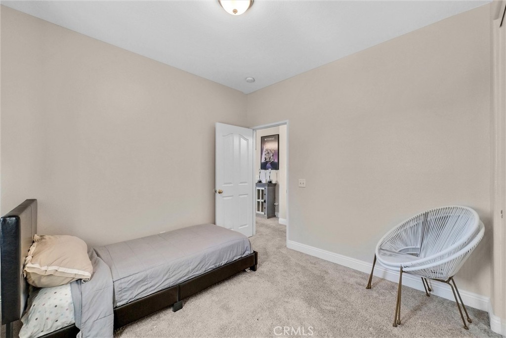 11499 Bridgeway Drive Riverside, CA 92505 - Photo 33 of 70 a bedroom with a bed and chair