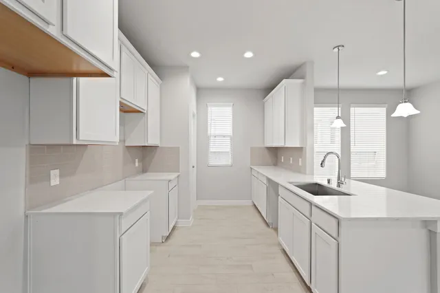 a kitchen with a sink stove and cabinets