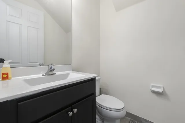 a bathroom with a sink a toilet and a mirror