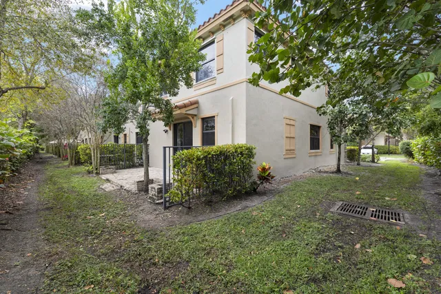 a view of a house with yard and a garden