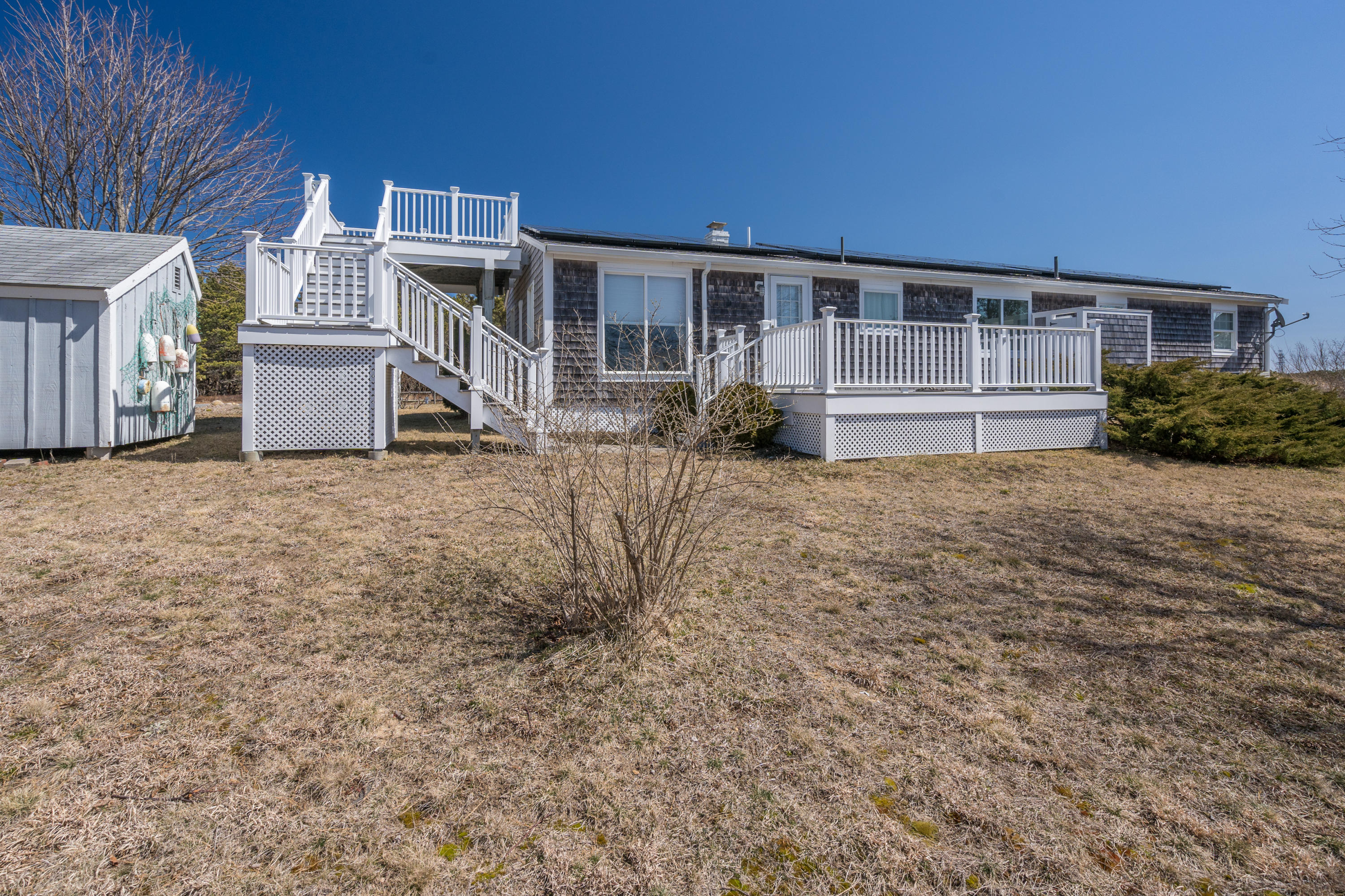 11 Bay View Drive Truro, MA 02666 - Photo 2 of 16 a view of backyard with a small cabin and chair