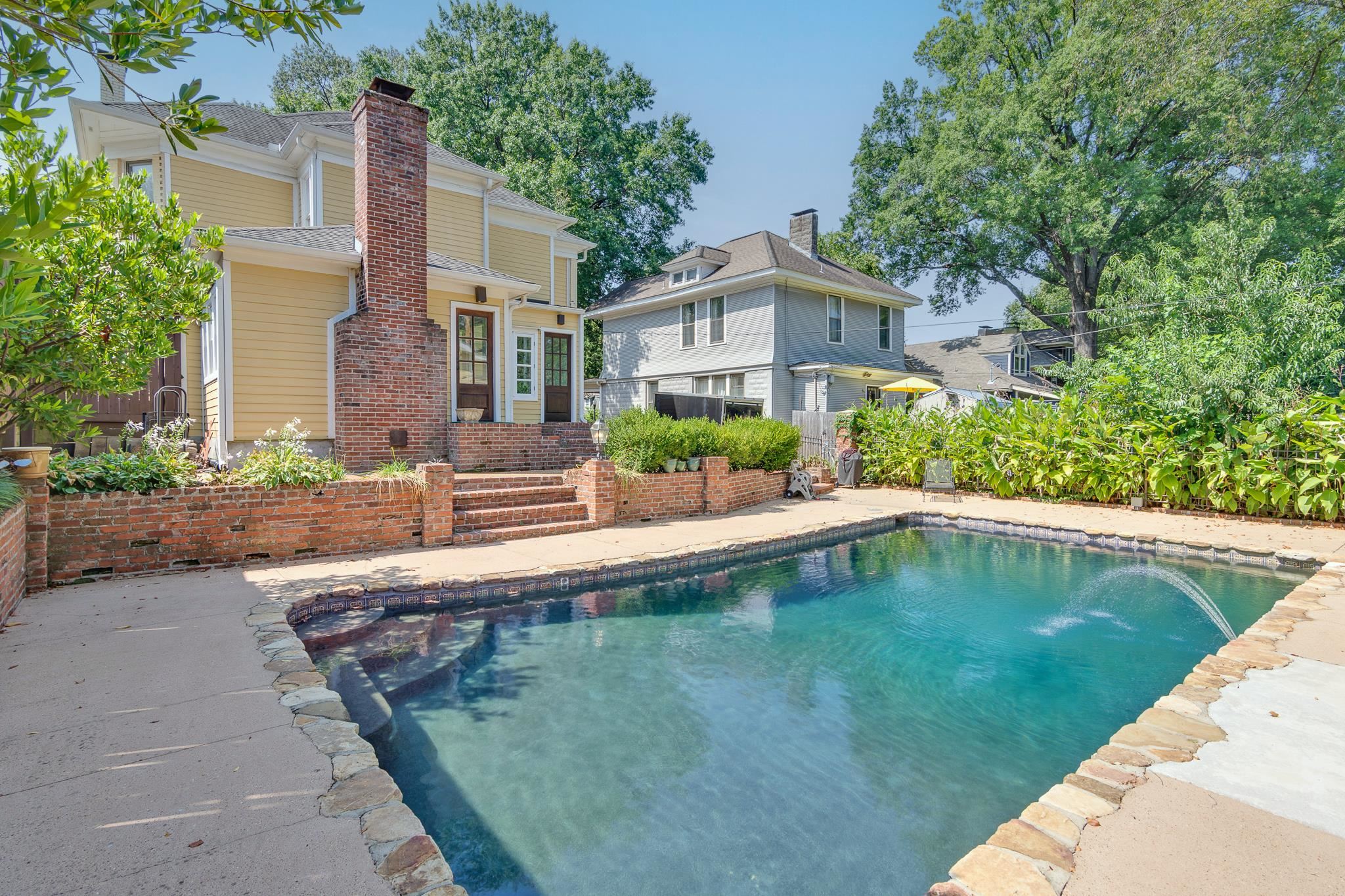 a swimming pool with outdoor seating and yard