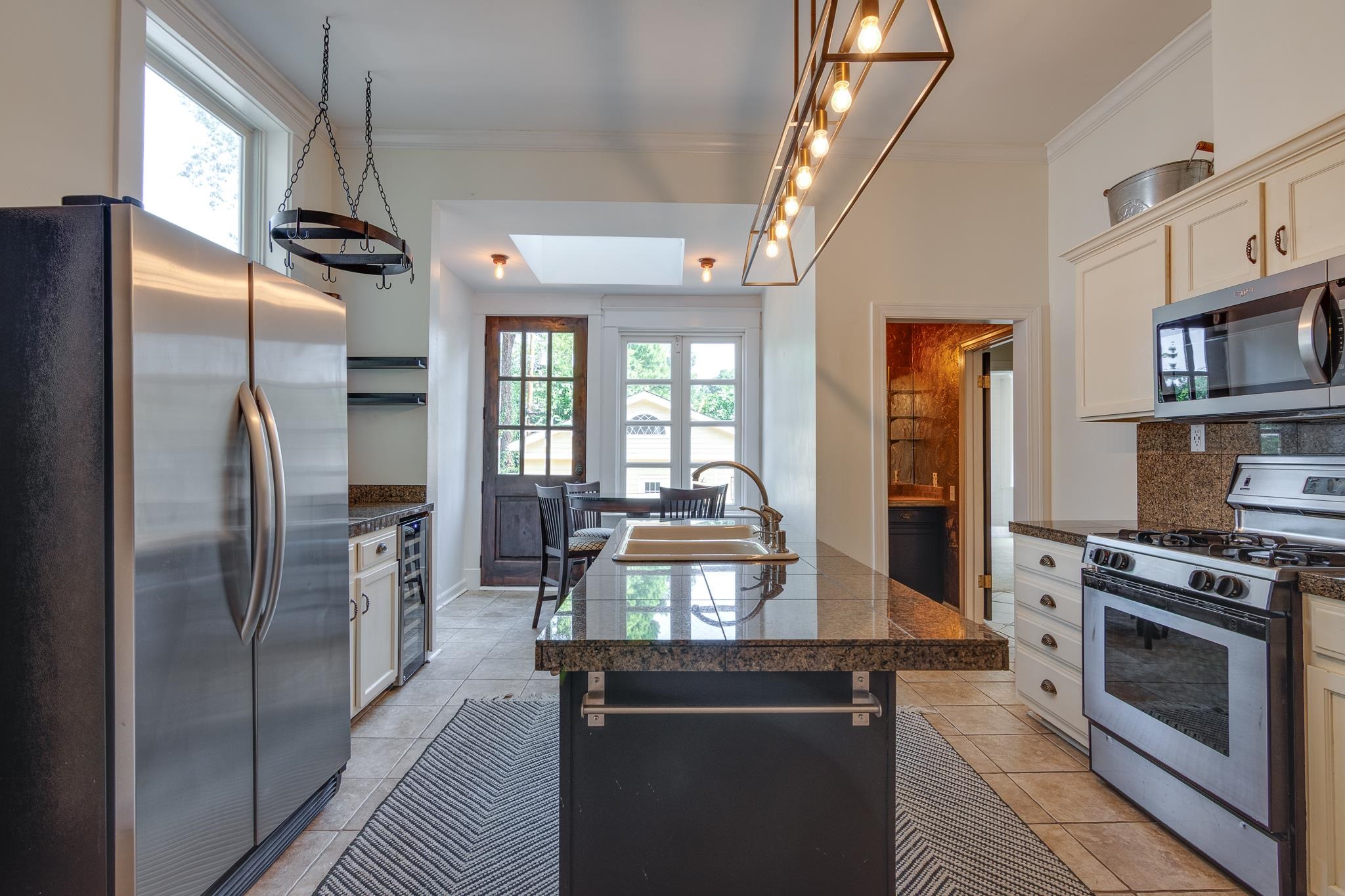 1680 Carruthers Place Memphis, TN 38112 - Photo 15 of 36 a kitchen with stainless steel appliances granite countertop a refrigerator a stove and a sink