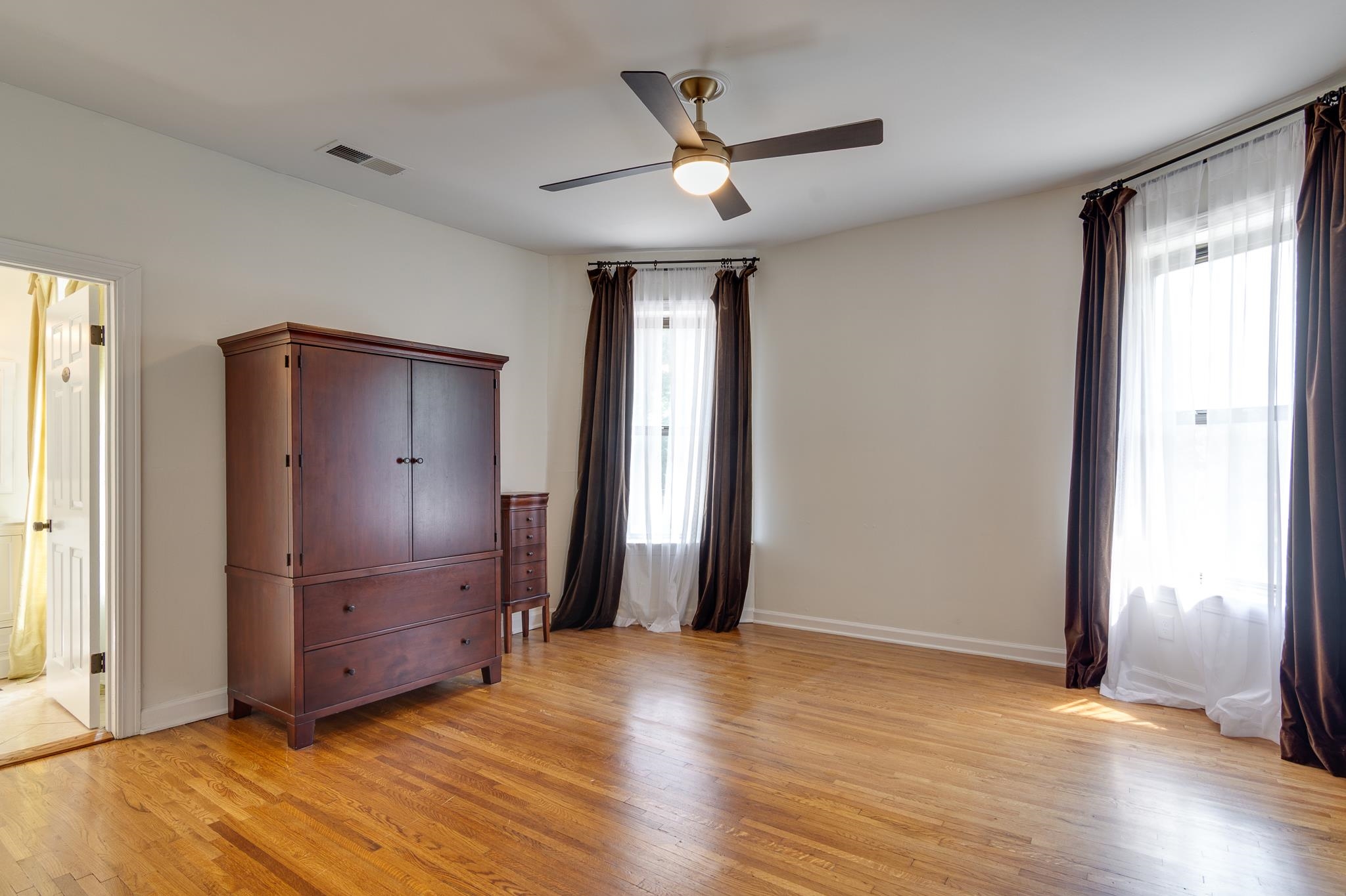 1680 Carruthers Place Memphis, TN 38112 - Photo 20 of 36 a view of an empty room with wooden floor and a window