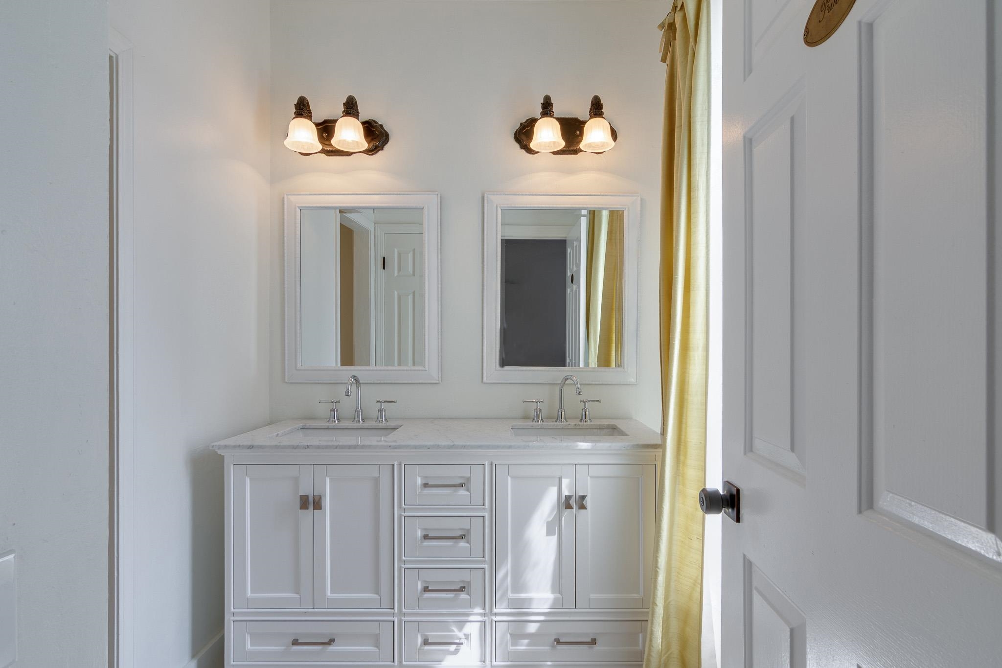 1680 Carruthers Place Memphis, TN 38112 - Photo 22 of 36 a bathroom with a granite countertop sink and a mirror