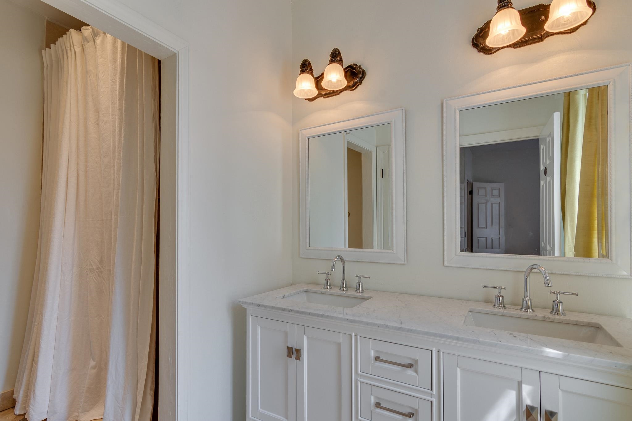 1680 Carruthers Place Memphis, TN 38112 - Photo 23 of 36 a bathroom with a granite countertop sink and a mirror