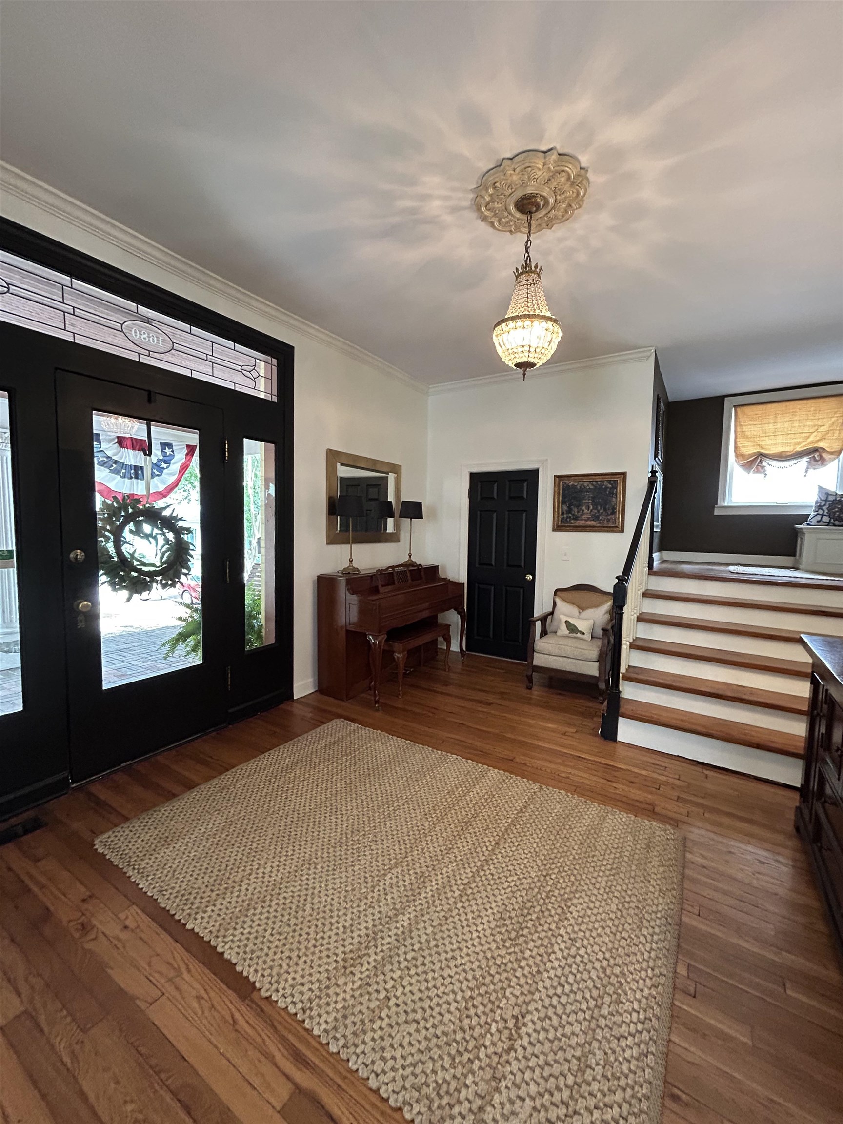 1680 Carruthers Place Memphis, TN 38112 - Photo 3 of 36 a bedroom with furniture a chandelier and wooden floor