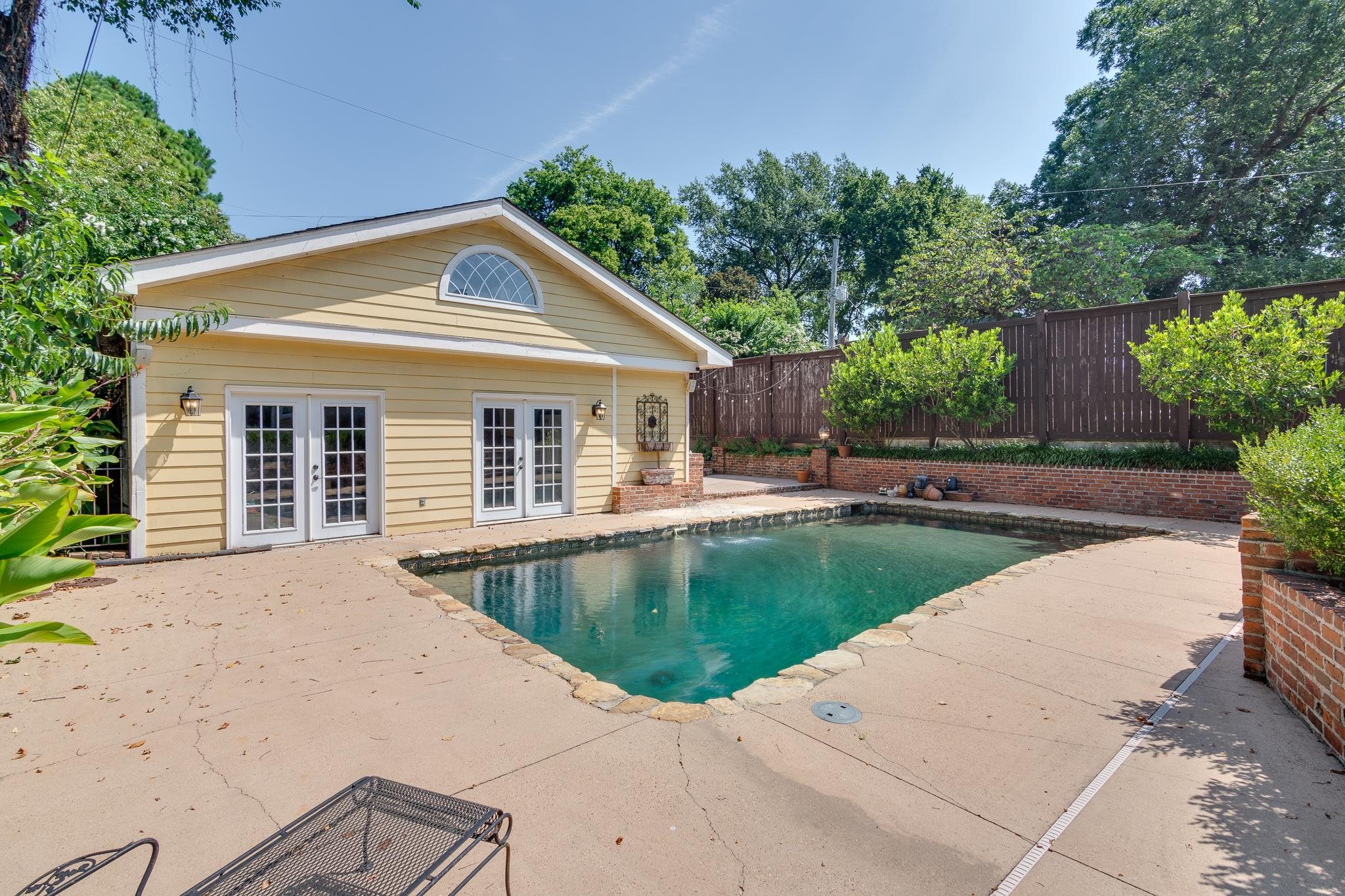 1680 Carruthers Place Memphis, TN 38112 - Photo 35 of 36 a view of a house with pool fire pit a patio and a garden
