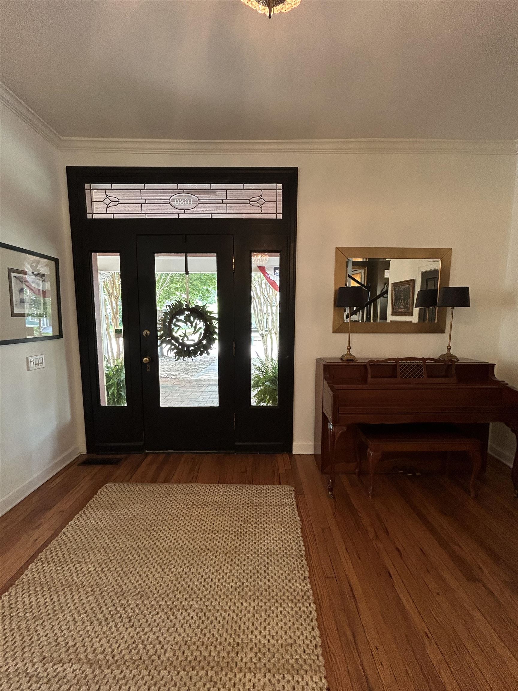 1680 Carruthers Place Memphis, TN 38112 - Photo 4 of 36 a view of a hallway with wooden floor and furniture