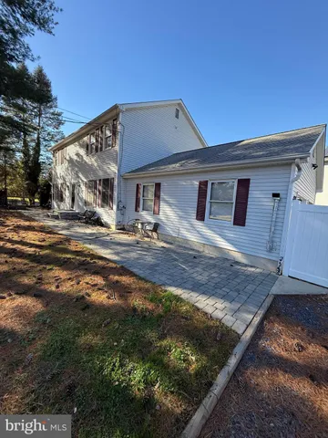 a front view of a house with trees