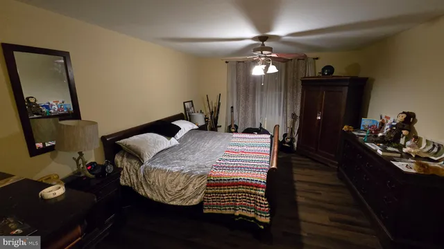 a bed room with a bed mirror and a desk