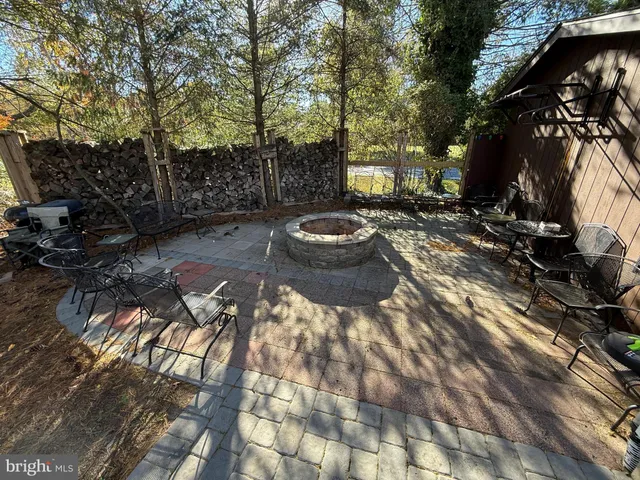 a view of a backyard with table and chairs and potted plants