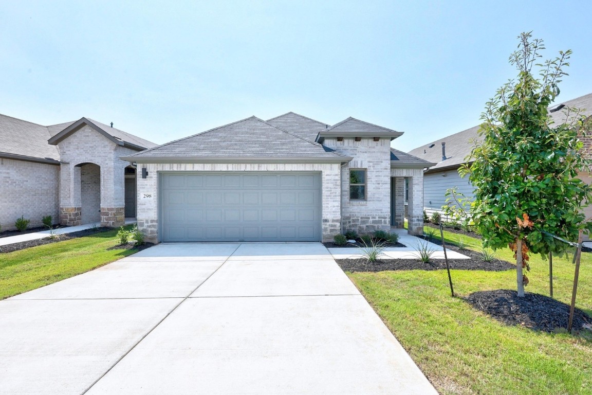 a front view of a house with a yard and garage