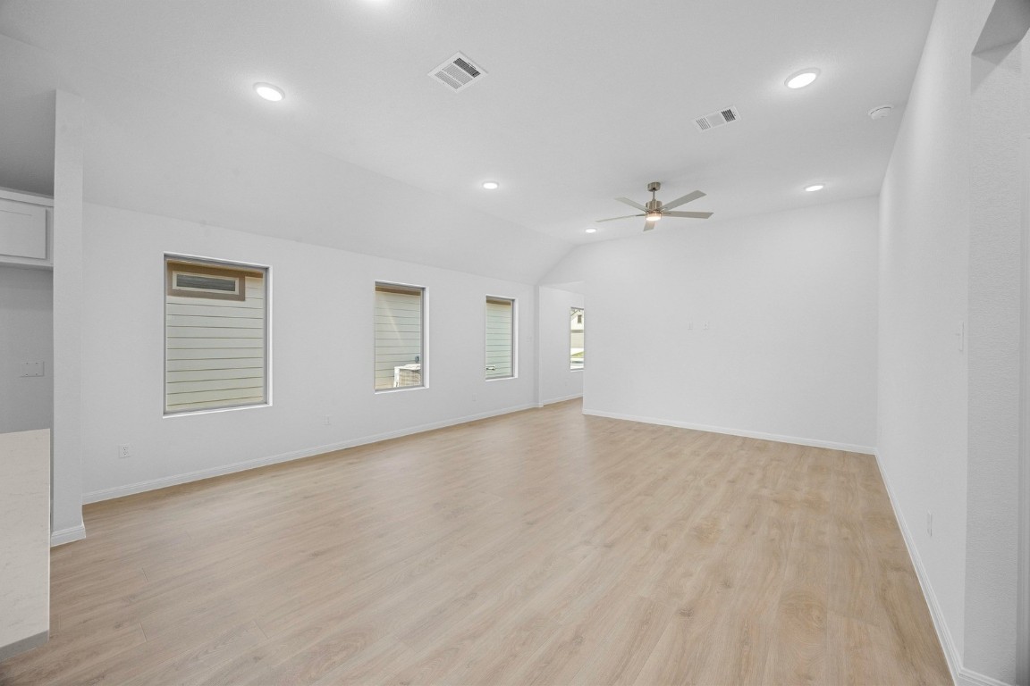 298 Bendecido Loop Elgin, TX 78621 - Photo 11 of 40 wooden floor in an empty room with a window