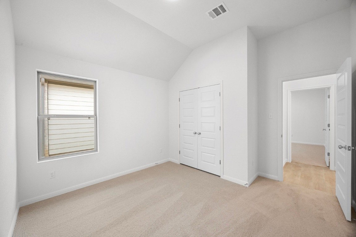 298 Bendecido Loop Elgin, TX 78621 - Photo 13 of 40 an empty room with windows and closet