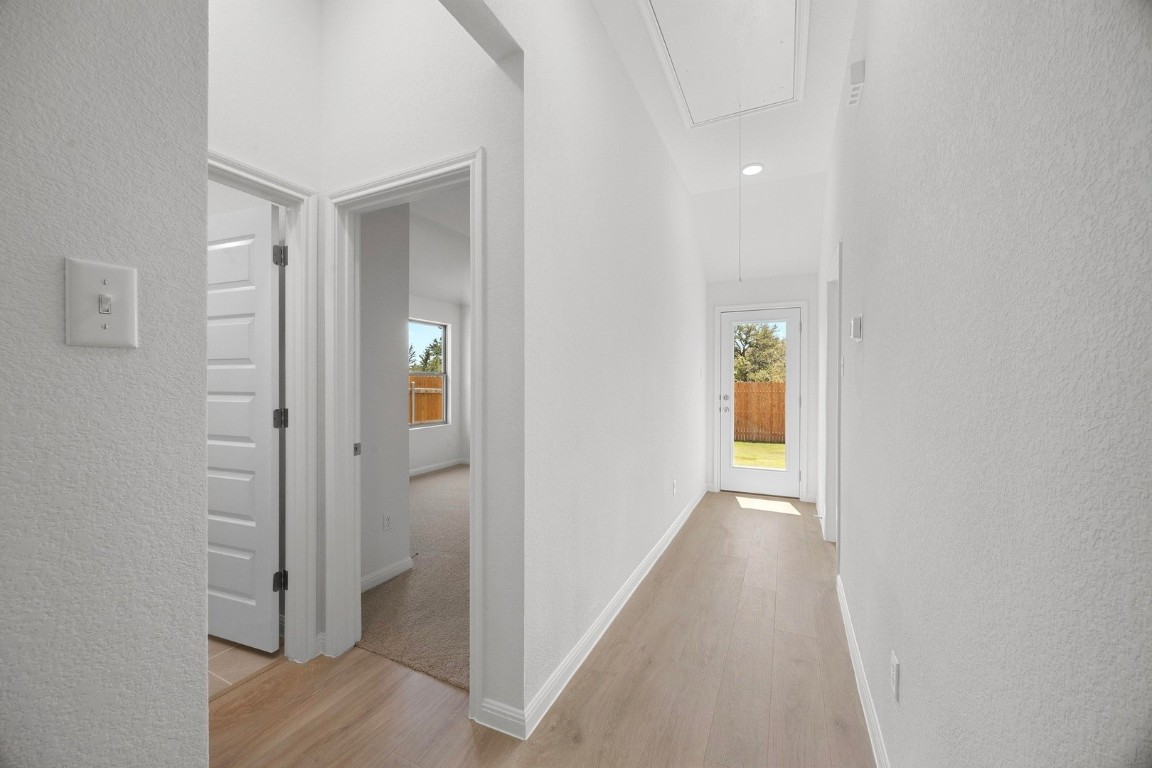298 Bendecido Loop Elgin, TX 78621 - Photo 17 of 40 wooden floor in a hall with an entryway