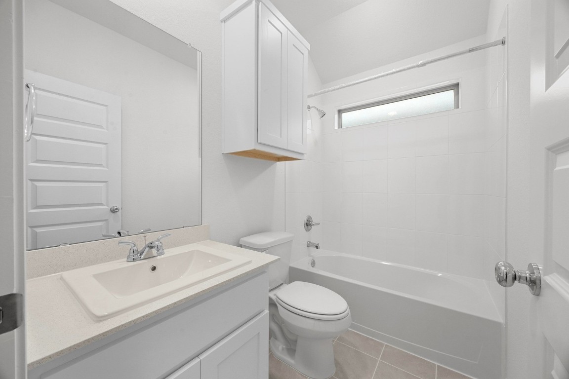 298 Bendecido Loop Elgin, TX 78621 - Photo 20 of 40 a bathroom with a sink a toilet and shower