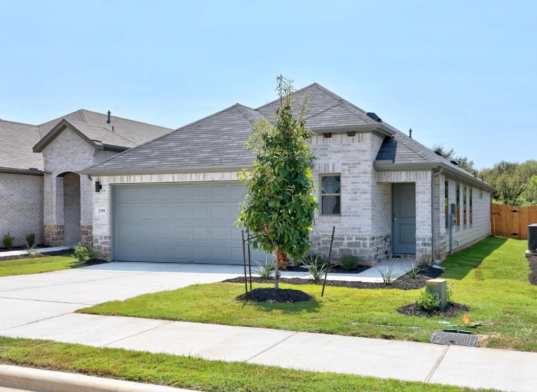 298 Bendecido Loop Elgin, TX 78621 - Photo 2 of 40 a front view of a house with a yard and garage