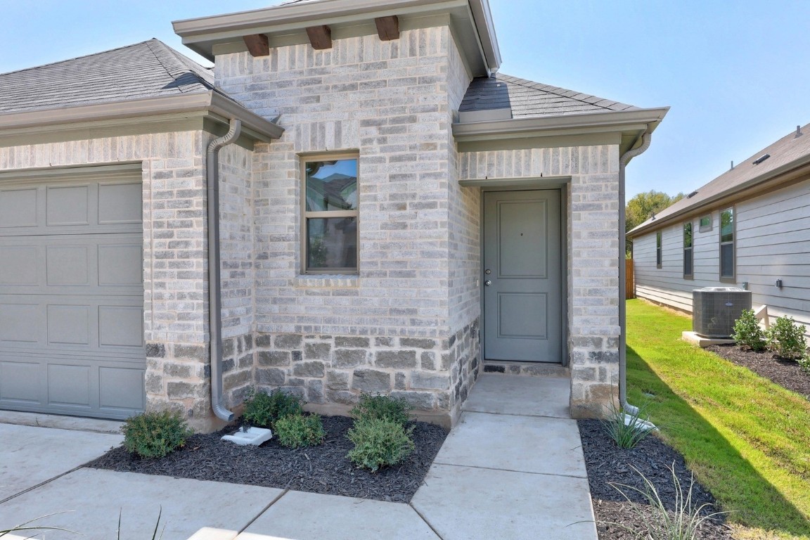 298 Bendecido Loop Elgin, TX 78621 - Photo 3 of 40 a front view of a house with garden