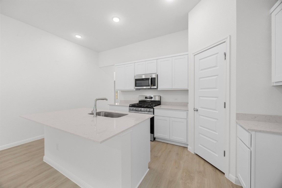 298 Bendecido Loop Elgin, TX 78621 - Photo 8 of 40 a kitchen with cabinets and appliances