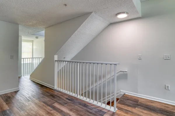 a view of entryway and hall with wooden floor