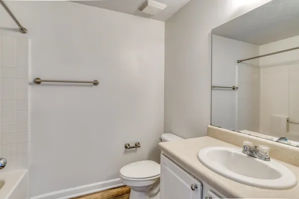 a bathroom with a sink toilet and a mirror