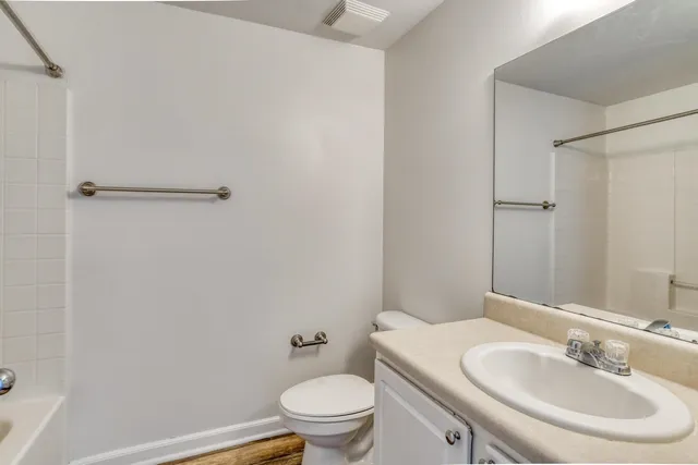 a bathroom with a sink toilet and a mirror