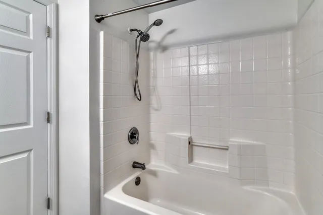 a bathroom with a bath tub with a shower