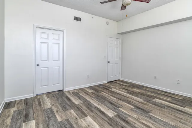 a view of room with hardwood floor and hallway