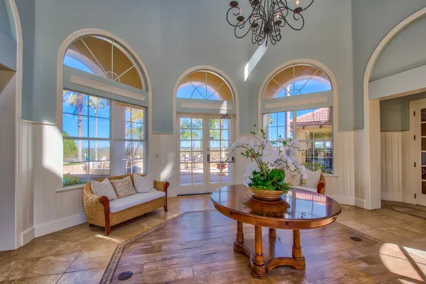 a living room with couches a table and a potted plant